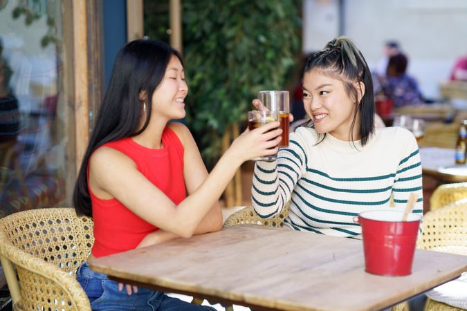 Two women sitting in restaurant patio with beverages