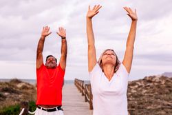 Couple practicing martial arts on lumber path