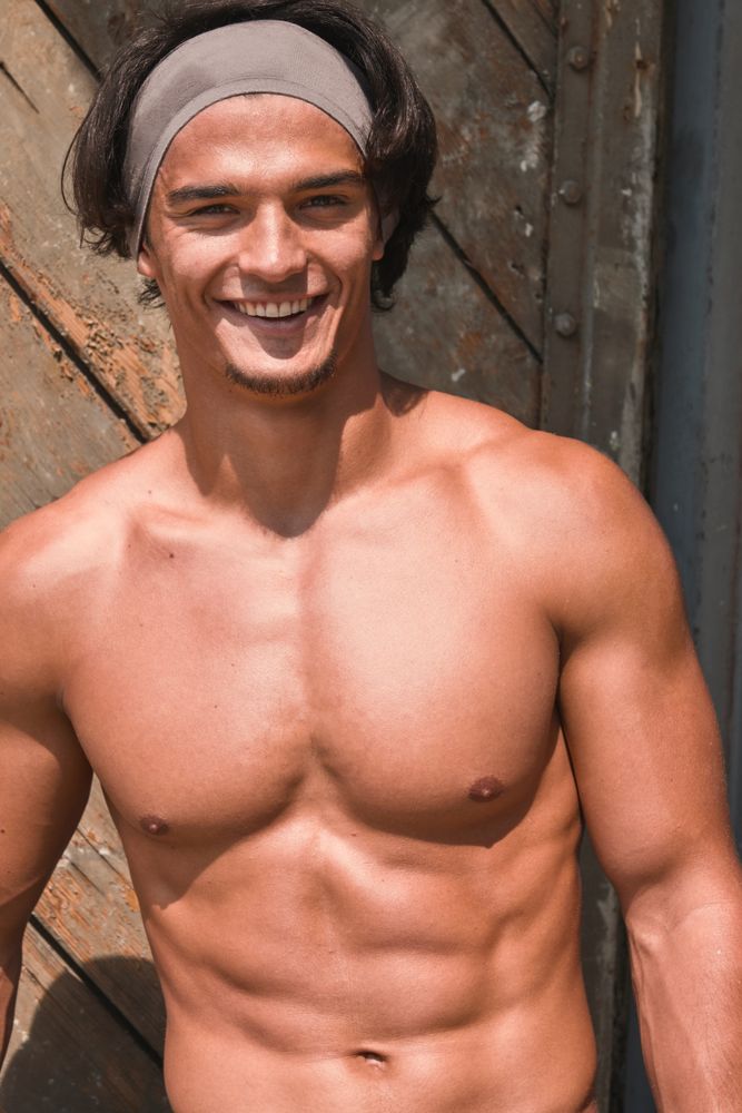 Muscular man posing in gym