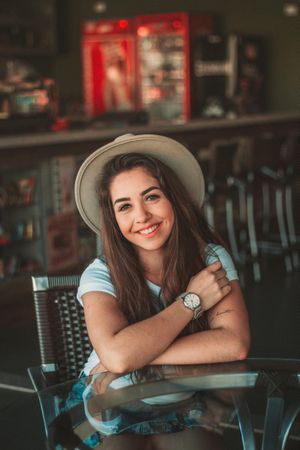 Woman wearing a hat sitting at a table