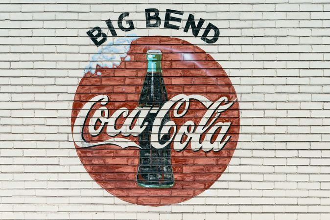 An old company sign appears on the wall of a Coca-Cola bottling plant outside Alpine, Texas