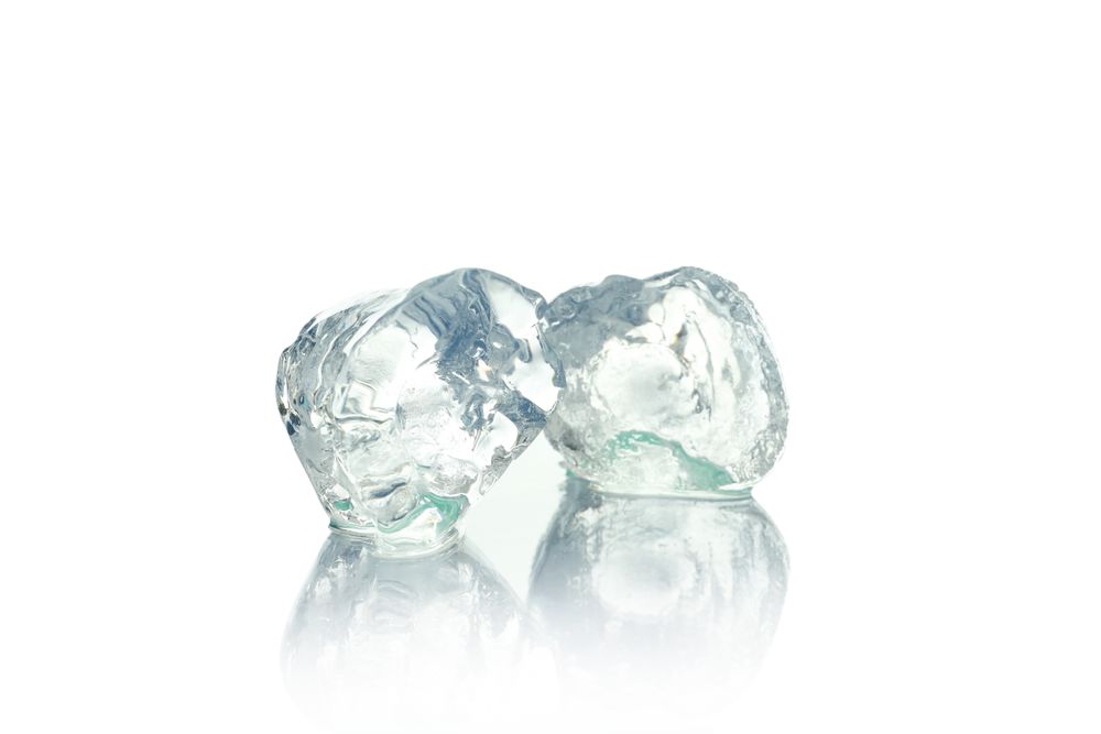 Three ice cubes in bright room
