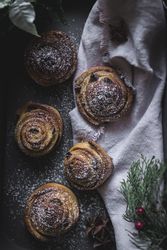 Herbs and napkin near cinnamon rolls