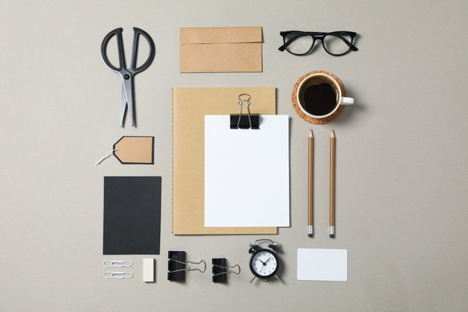 Mockup. Corporate stationery, glasses and alarm clock on grey background. Flat lay
