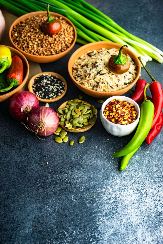 Dark kitchen counter with grains and aromatics for dinner