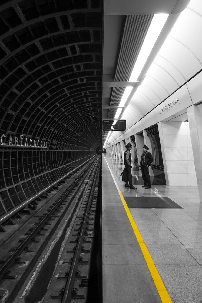 Two people waiting in subway