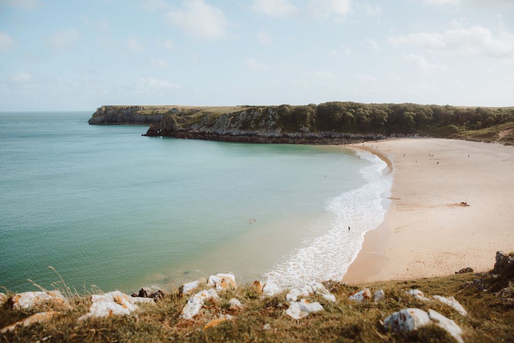 Sandy beach between long cliffs by sea