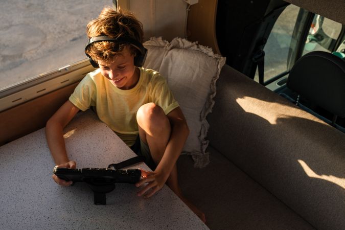 Boy watching comedy in caravan