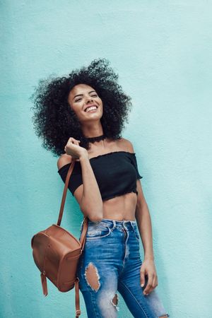 Happy woman wearing casual clothes with turquoise background