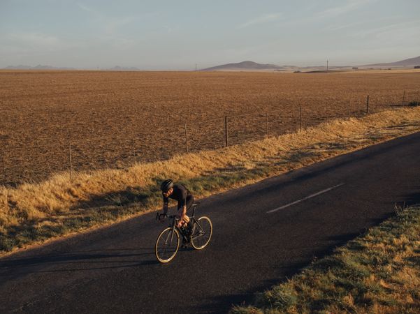 Athlete riding a pro bike on countryside road