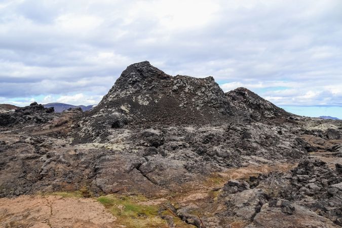 Rocky mountain with a patch of grass on the side