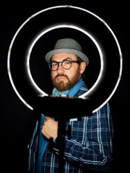 Stylish man in elegant suit behind special circle light