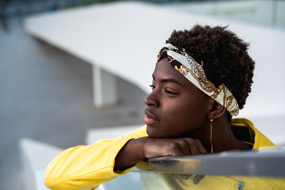Satisfied female having rest on stairs in city
