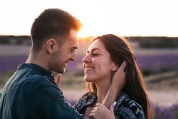 Couple in love in a lavender field at sunset