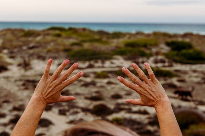 Crop person gesturing hands in nature