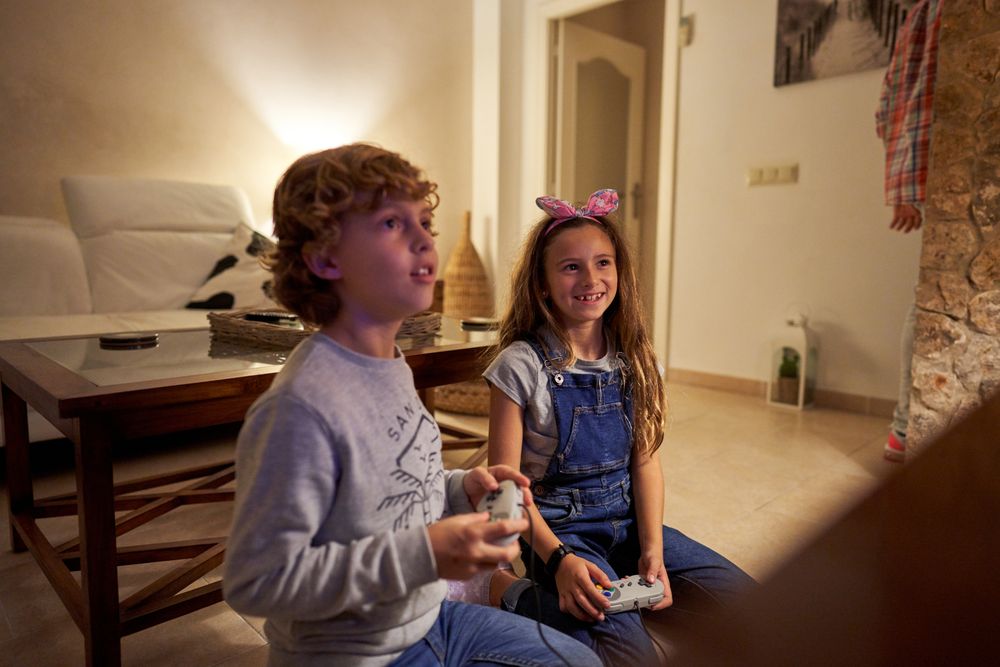 Children playing video games at home