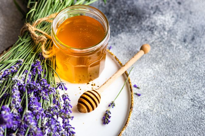 Pot of honey with bunch of lavender with space for text