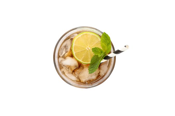 Glass of cold cola with lime isolated on blank background