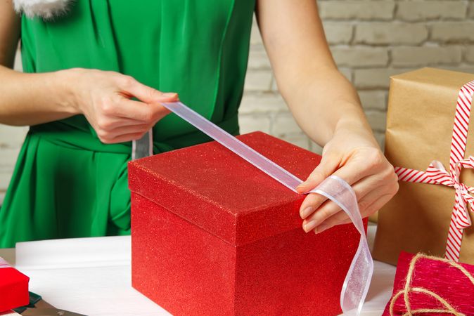 Woman packing red gift box