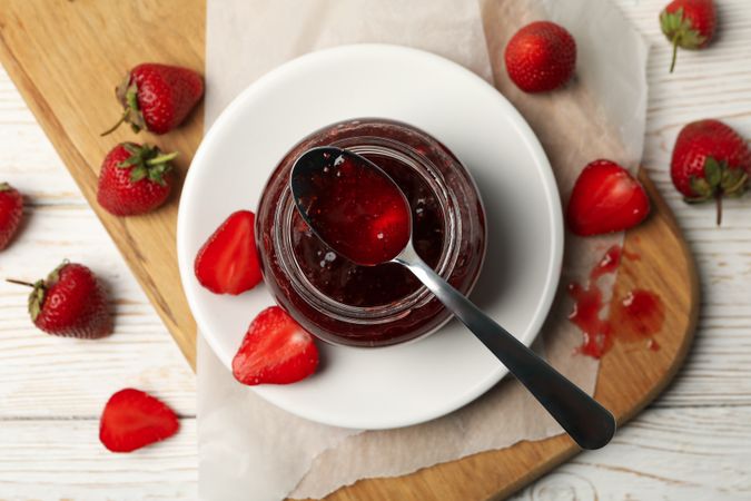 Composition with strawberry jam on wooden background, top view