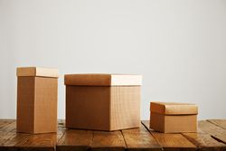 Three cardboard boxes on wooden table