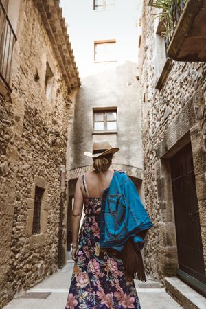Woman walking in a narrow path in a village