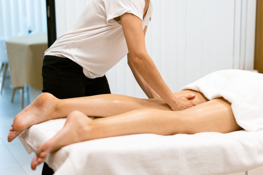 Massage therapist working on a client’s upper leg