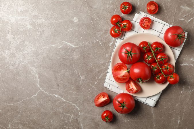 Composition with tomatoes on gray background, top view