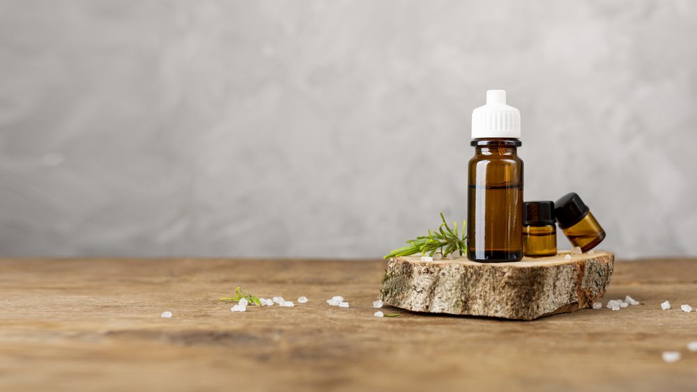 Arrangement with essential oils on wooden table