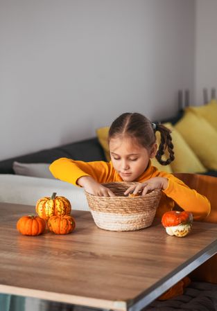 Little Girl Playing With a Pumpkin.