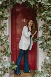 Stylish woman looking away near red door