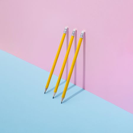 School pencils leaning on pastel background