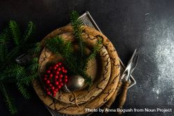 Top view of rustic plates with xmas pine and ornament with copy space 42vEm4