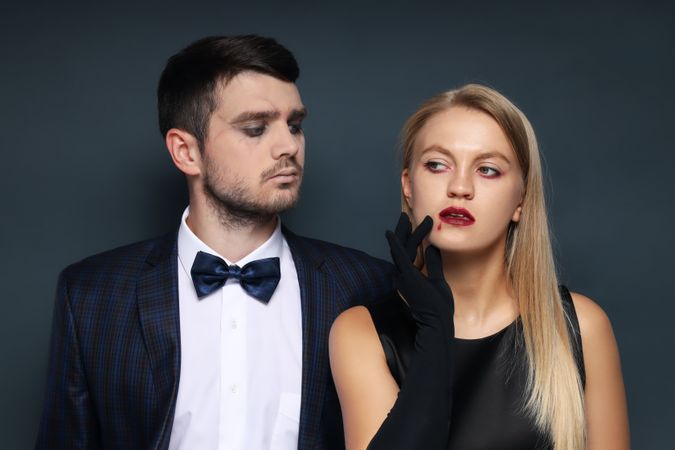 Concept of Halloween, young man and woman on dark background