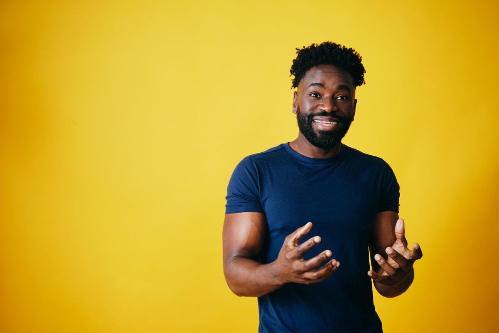 Portrait of Black man explaining something in studio shoot