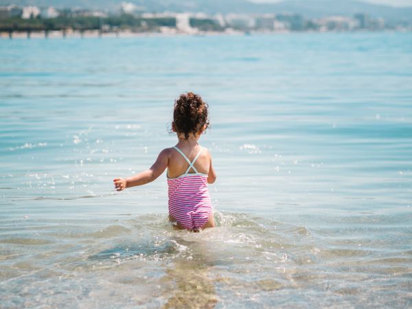 Cheerful girl having fun in warm sea