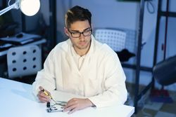 Young man repairing modern device