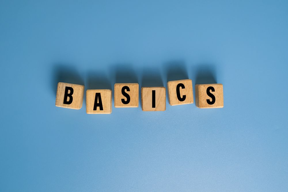 basics word on wooden blocks isolated on blue background