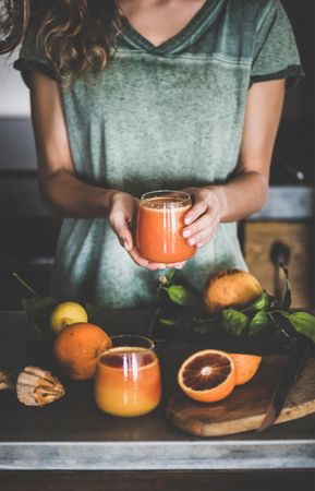 Woman holding glass of freshly squeezed blood orange juice
