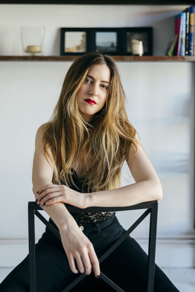 woman in bra sitting on chair