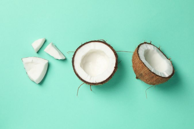Flat lay with coconut on mint background. Tropical fruit