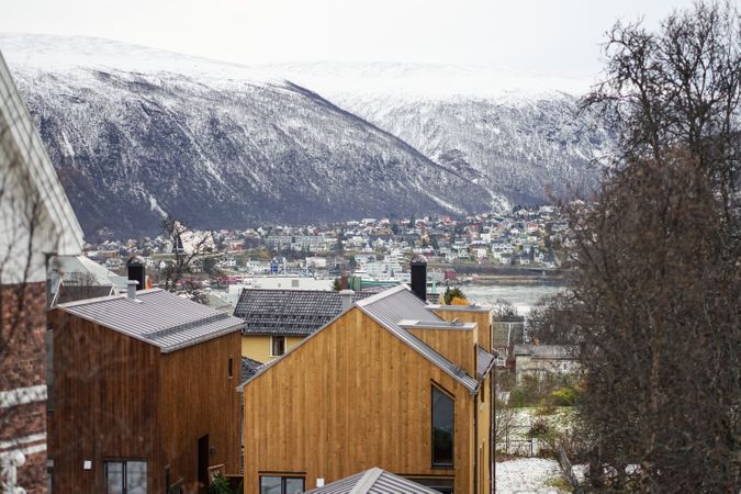 Wonderful scenery of winter city against snowy highland in cold overcast weather