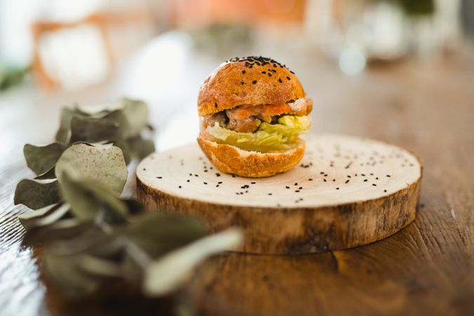 Delicious hamburger with sesame on wooden tray