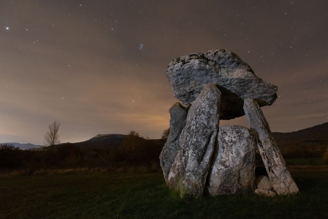 Ancient dolmen against night sky