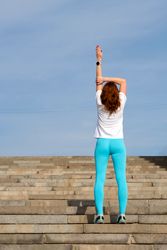 Woman doing warm up before workout on street