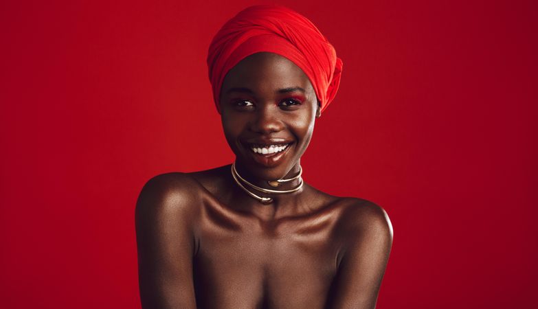 Close up of attractive African woman on red background