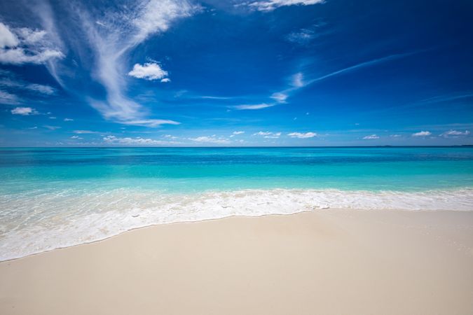 Waves coming up onto a clean tropical beach