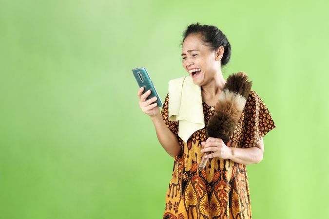 Indonesian Mom Wearing Looking at Cell Phone