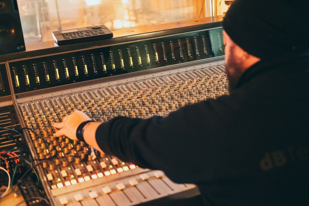 Man in a equalizer instrument in a studio