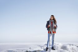 Young adult woman outdoors travelling in icy landscape